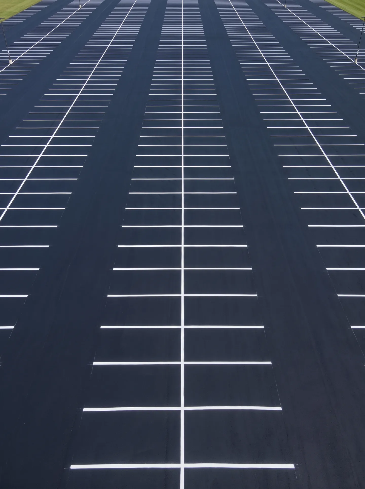 Asphalt-emulsion sealcoat being applied to a commercial parking lot